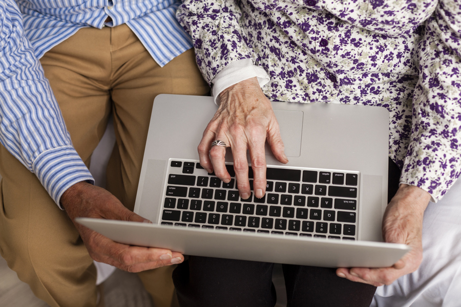 senior couple from above using laptop