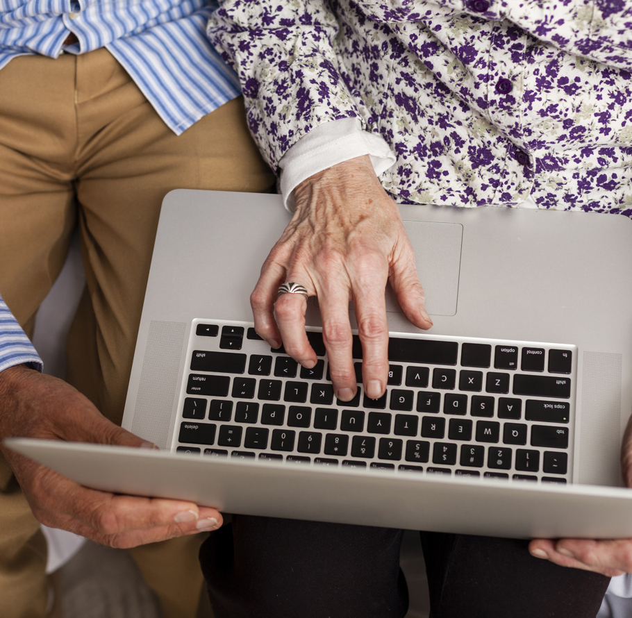 senior couple from above using laptop