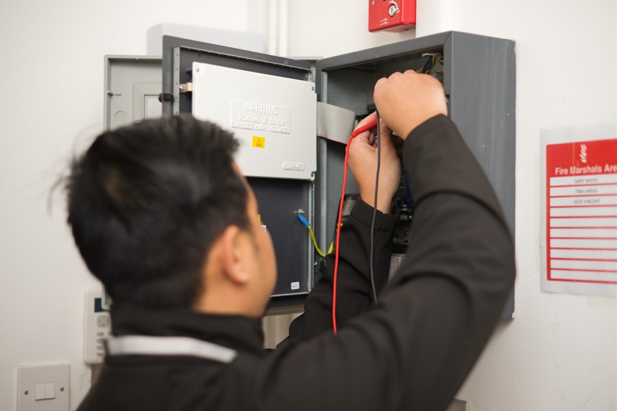 Man working on electric fuse box