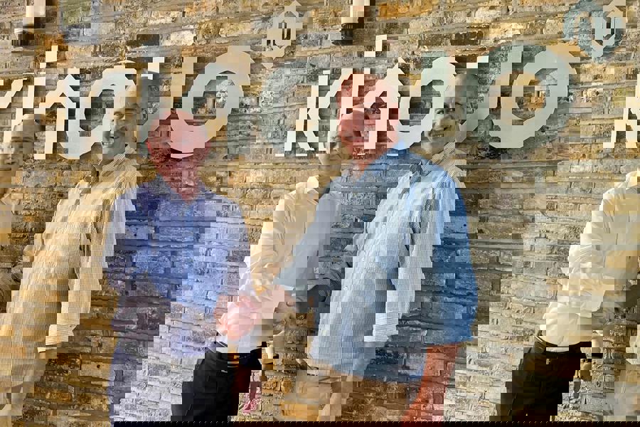 Picture of handshake and 2 men smiling